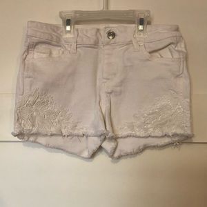 White denim shorts with lace details